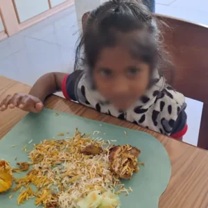 A young girl at Tamar House enjoying a plate of food during a supportive team visit.