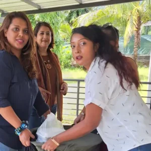 Team members carefully transporting a large pot of food into the shelter during their visit.